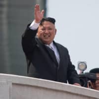 North Korean leader Kim Jong Un waves following a military parade in Pyongyang in 2017. | AFP-JIJI