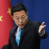 Chinese Foreign Ministry new spokesman Zhao Lijian gestures as he speaks during a daily briefing at the Ministry of Foreign Affairs office in Beijing. From Asia to Africa, London to Berlin, Chinese envoys have set off diplomatic firestorms with a combative defense whenever their country is accused of not acting quickly enough to stem the spread of the coronavirus pandemic.  | AP