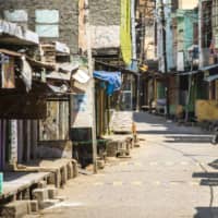 A cow stands on a deserted street during a partial lockdown imposed due to the coronavirus in a town in the Gautam Buddh Nagar district of Uttar Pradesh, India, on April 21.  | BLOOMBERG