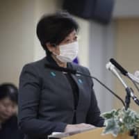 Tokyo Gov. Yuriko Koike speaks with a mask on while urging residents to further isolate themselves, during a news conference on April 24. | RYUSEI TAKAHASHI
