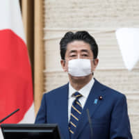 Prime Minister Shinzo Abe attends a news conference at his official residence on April 7. | POOL / VIA REUTERS
