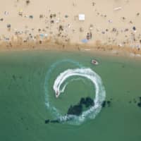 People visit a beach in Sokcho, on South Korea\'s northeast coast, during a long public holiday weekend on Saturday. | AFP-JIJI