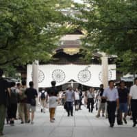 People visit the Yasukuni Shrine, dedicated to the memory of Japan\'s war dead, in Tokyo on Aug. 15, 2019. | BLOOMBERG

