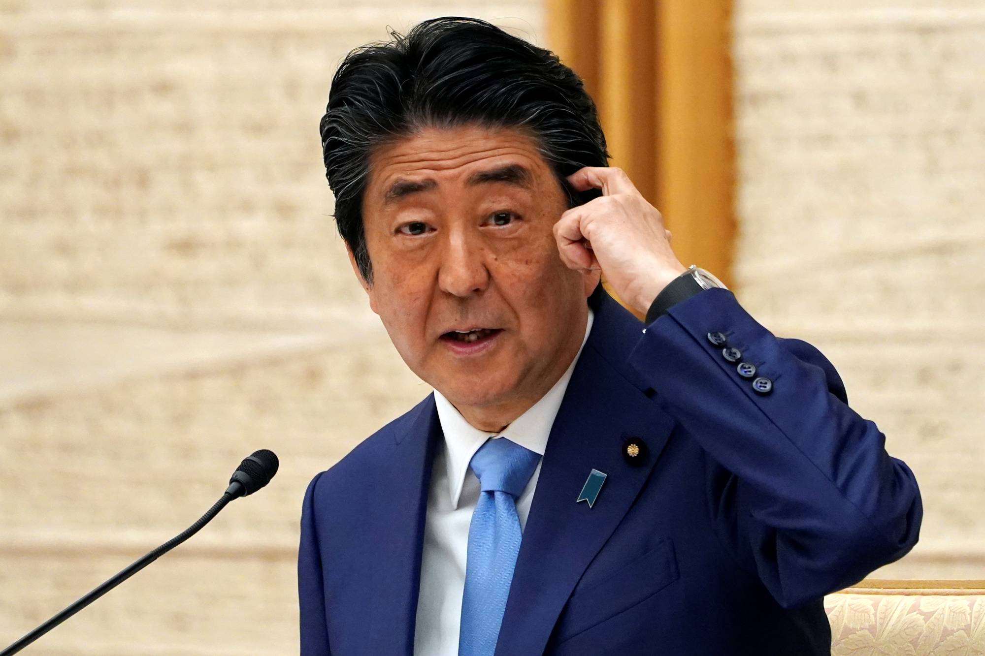 Prime Minister Shinzo Abe speaks during a news conference announcing an extension of the nationwide state of emergency, at the Prime Minister's Office in Tokyo on Monday. | POOL / VIA REUTERS