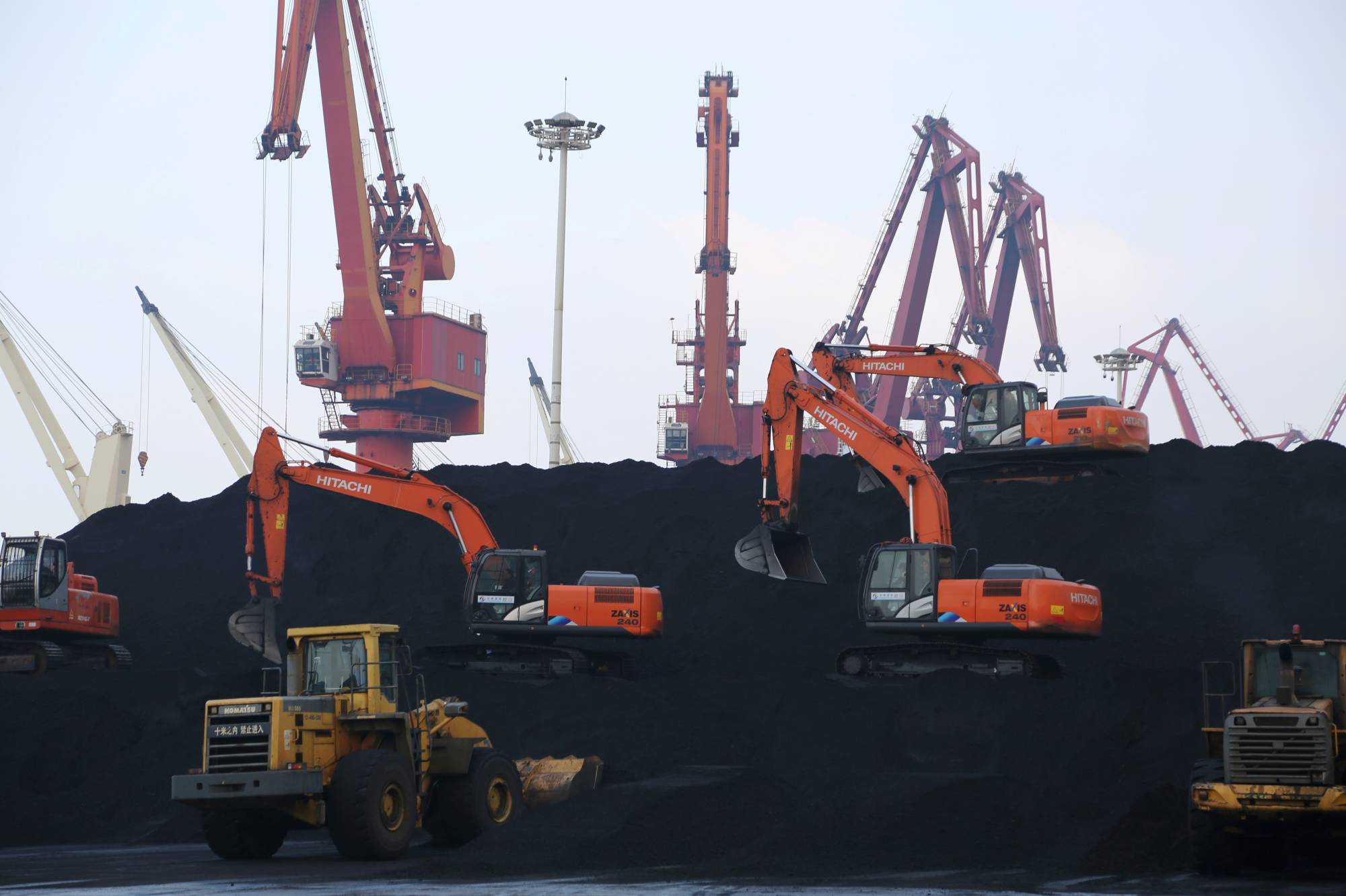 Workers unload imported coal at a port in Lianyungang, Jiangsu province, China, in December. A retreat from financial institutions in developed countries has paved the way for Chinese companies to invest in the coal industry in Africa.  | VIA REUTERS