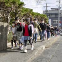 Elementary school children walk to school in the city of Tottori Thursday morning as schools in the prefecture reopened. | KYODO