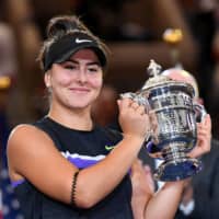 Canada\'s Bianca Andreescu holds the U.S. Open championship trophy after beating Serena Williams in the women\'s singles final on Sept. 7 in Flushing, New York. | USA TODAY / VIA REUTERS