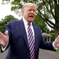 U.S. President Donald Trump speaks to reporters on the South Lawn of the White House as he departs on travel to Phoenix, Arizona, in Washington on Tuesday.  | REUTERS