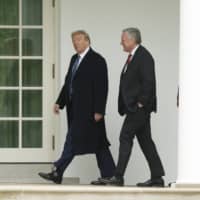 U.S. President Donald Trump and Mark Meadows, White House chief of staff walk to the Oval Office following a wreath-laying ceremony in Washington on Friday. The United States issued a new rule the same day tightening visa guidelines for Chinese journalists. | EPA / VIA BLOOMBERG