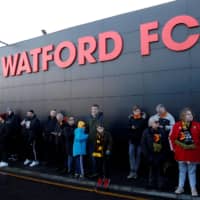 Fans wait outside Watford\'s home stadium of Vicarage Road on Feb. 29 in Watford, England. | REUTERS