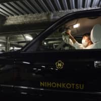 Nihon Kotsu Co. taxis deliver food from high-end restaurants such as Wolfgang’s Steakhouse in Tokyo. | BLOOMBERG