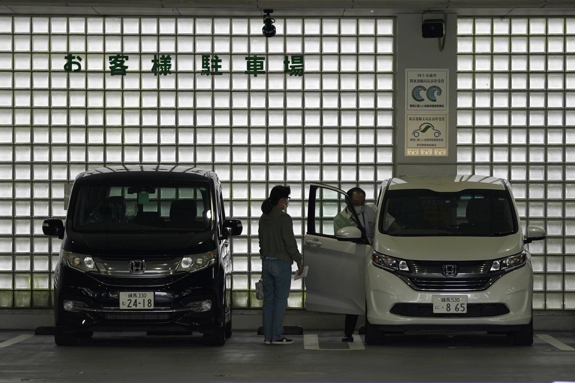 Honda Motor Co. vehicles are parked at a dealership in Tokyo on Sunday. | BLOOMBERG