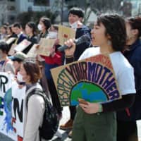Yayako Suzuki, 21, a member of FFF Tokyo and FFF Yokosuka, leads a protest in March against the construction of a coal power plant, in front of Yokosuka City Hall in Kanagawa Prefecture. | RYUSEI TAKAHASHI

