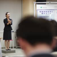 During Tokyo Gov. Yuriko Koike’s message to the residents of Tokyo, her sign language interpreter appeared wearing a clear mask, enabling viewers to lip read. | RYUSEI TAKAHASHI
