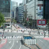 Fewer people than usual are seen at the Shibuya scramble crossing in central Tokyo on Tuesday.  | RYUSEI TAKAHASHI
