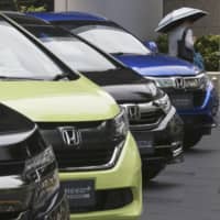 Honda cars are displayed at the automaker\'s headquarters in Tokyo. The Japanese automaker sank deeper into losses for the fiscal quarter ended in March 2020, as the damage to the industry set off by the coronavirus outbreak hurt sales and crimped production. | AP