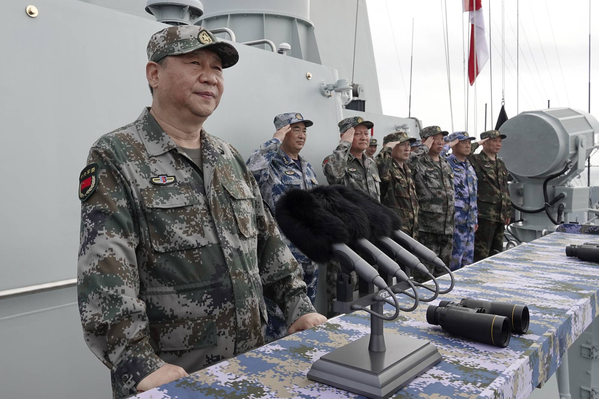Chinese President Xi Jinping speaks after reviewing the Chinese People's Liberation Army Navy fleet in the South China Sea in April 2018. The Chinese military is planning to conduct a large-scale landing drill in the waterway in August to simulate the possible seizure of the Taiwanese-held Pratas Island in the future, sources have said. | XINHUA / VIA AP