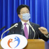 Health minister Katsunobu Kato speaks at a news conference at the ministry Friday. | KYODO