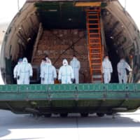 A cargo plane carrying protective masks from China is unloaded at the airport in Leipzig, Germany, on April 27. | REUTERS 