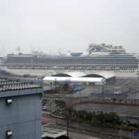 Carnival Corp.\'s Diamond Princess waits at a dock off Yokohama in February after being quarantined. | BLOOMBERG 