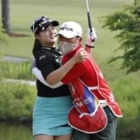 Park Hyun-kyung (left) celebrates with her father after winning the KLPGA Championship on the 18th hole at Lakewood Country Club in Yangju, South Korea, on Sunday. | AP