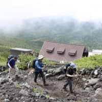 People climb Mount Fuji on July 10, 2019, the first day of the climbing season. | KYODO
