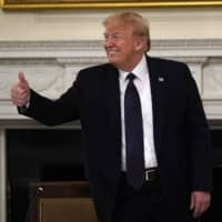 U.S. President Donald Trump gestures as he leaves a meeting with restaurant industry executives about the coronavirus response, in the State Dining Room of the White House on Monday.  | AP