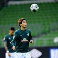 Werder Bremen\'s Yuya Osako warms up before a match against Bayer Leverkusen in Bremen, Germany, on Monday. | POOL / VIA REUTERS