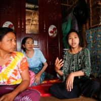 Zarchi Liwn, one of hundreds of thousands of garment workers across Asia who have been laid off, talks to reporters in her hostel in an industrial zone on the outskirts of Yangon, Myanmar, last month.  | REUTERS