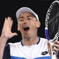 John Millman reacts during a match against Roger Federer at the Australian Open on Jan. 24 in Melbourne. | AP