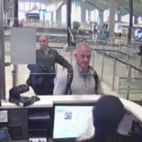 This Dec. 30, 2019 image from security camera video shows Michael L. Taylor, center, and George-Antoine Zayek at passport control at Istanbul Airport in Turkey. | DHA VIA AP