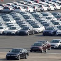 New cars await export at Yokohama port, near Tokyo. | REUTERS