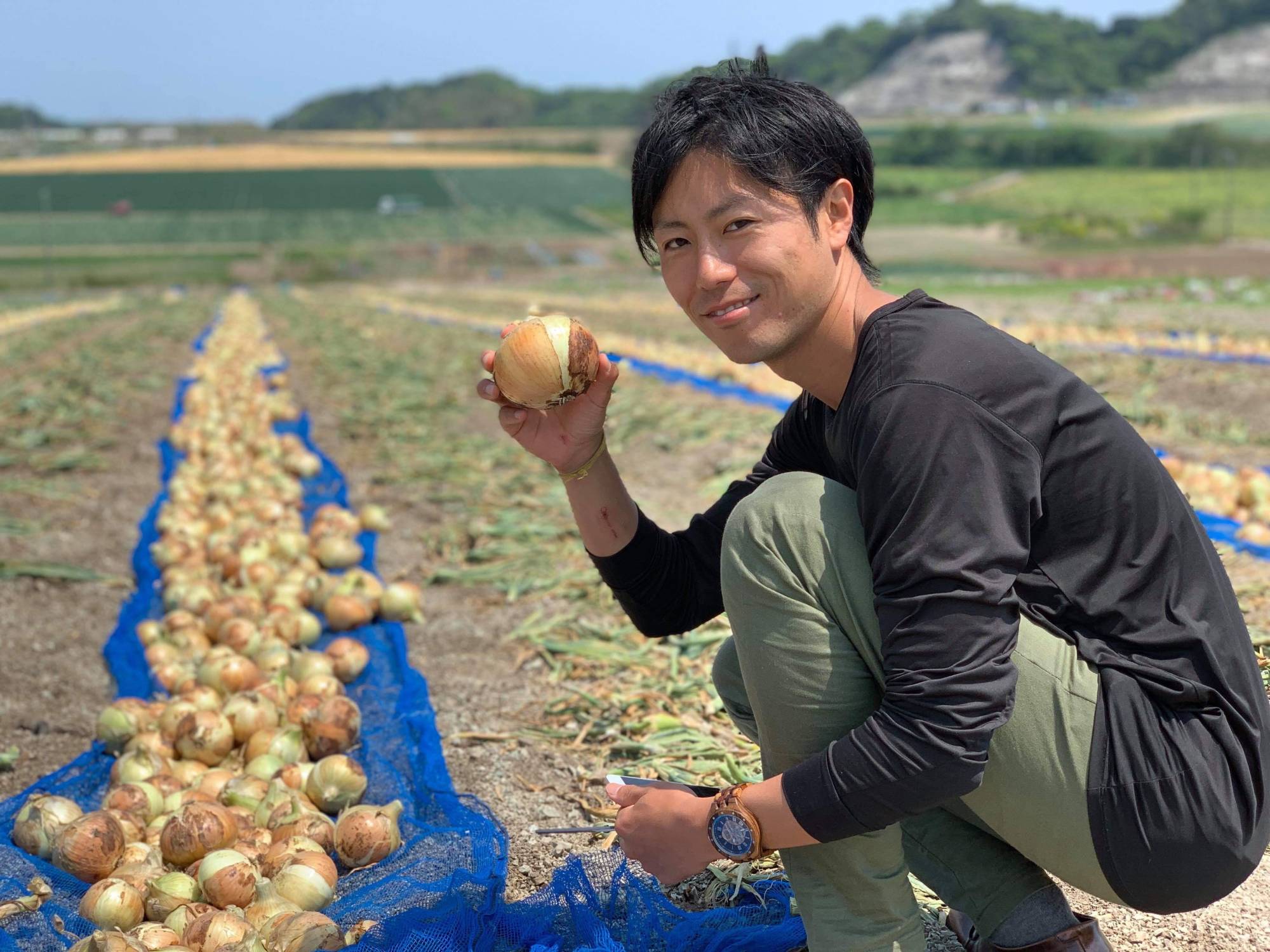 Nurturing people and plants: Hiroki Kashiwagi at his farm on Awaji Island, a region known for its quality onions. | Bioagri 