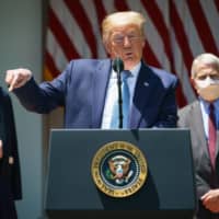 U.S. President Donald Trump speaks on vaccine development, in the Rose Garden of the White House in Washington on May 15. Flanking Trump are White House Coronavirus Task Force members Deborah Birx and Anthony Fauci, director of the National Institute of Allergy and Infectious Diseases. | AFP-JIJI