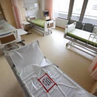 Many hospitals have been forced to suspend part of their emergency care to treat COVID-19 patients, according to a survey. | KYODO