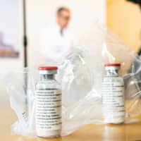 The drug remdesivir is seen during a news conference at the University Hospital Eppendorf in Hamburg, Germany, in April. | POOL / VIA REUTERS