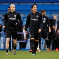 Frankfurt\'s Makoto Hasebe (right) and Sebastian Rode walk on the field during training on May 8, 2019. | REUTERS