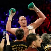 Tyson Fury celebrates his WBC heavyweight title win over Deontay Wilder on Feb. 22 in Las Vegas. | REUTERS