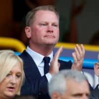 Huddersfield owner Phil Hodgkinson applauds during a game between his club and Derby County on Aug. 5 in Huddersfield, England. | REUTERS
