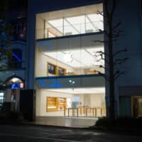An Apple Inc. store stands closed at night in the Shibuya district of Tokyo on April 12 under the state of emergency. Apple is reopening some stores in Japan this week. | BLOOMBERG
