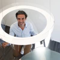 Designer Christophe Gernigon poses with a prototype of Plex\'Eat, a plexiglass bubble that he designed to  protect diners from the novel coronavirus as restaurants in France prepare to re-open following a long lockdown. | REUTERS