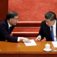 Chinese President Xi Jinping and Wang Yang, chairman of the National Committee of the Chinese People\'s Political Consultative Conference, speak at the second plenary session of the National People\'s Congress at the Great Hall of the People in Beijing on Monday.  | REUTERS 