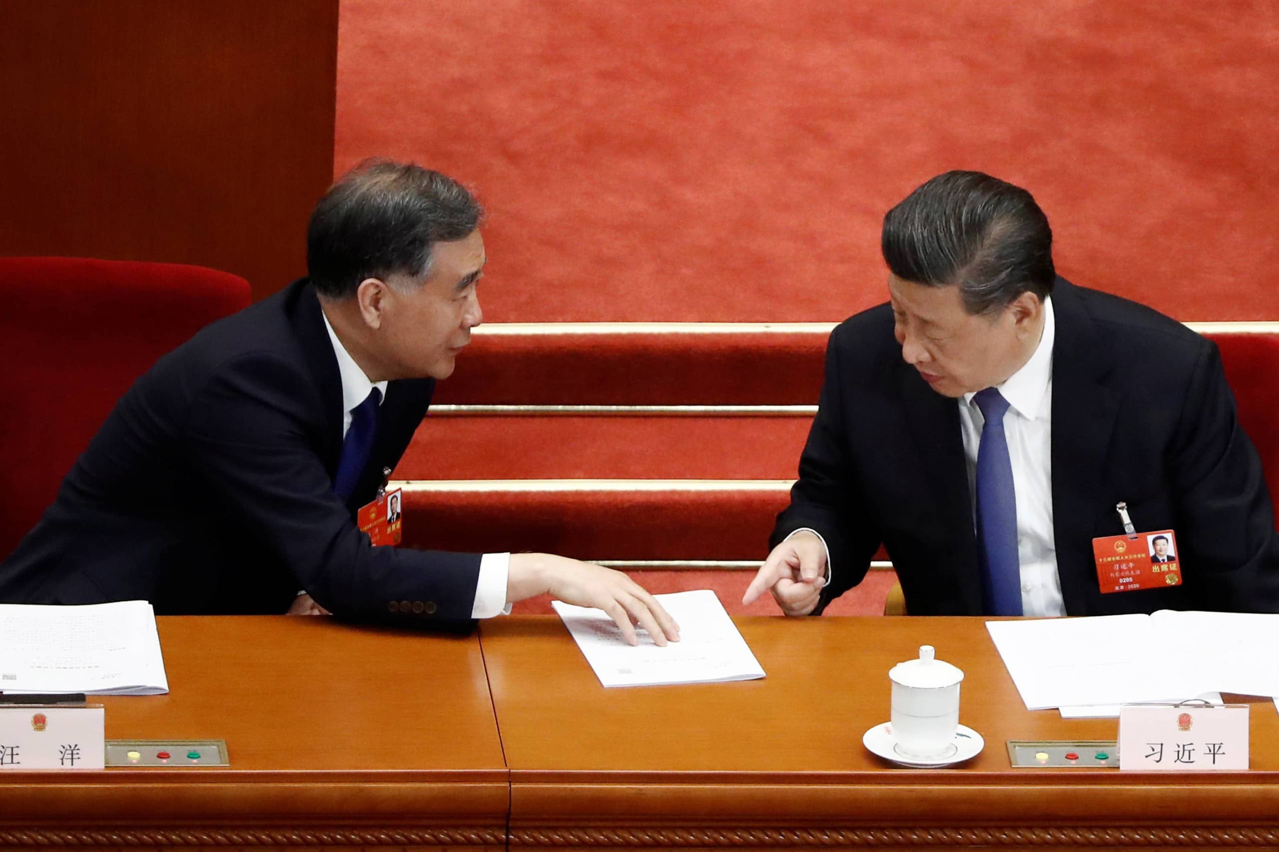Chinese President Xi Jinping and Wang Yang, chairman of the National Committee of the Chinese People's Political Consultative Conference, speak at the second plenary session of the National People's Congress at the Great Hall of the People in Beijing on Monday.  | REUTERS 