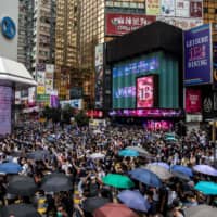 Pro-democracy protesters gather in the Causeway Bay district of Hong Kong on Sunday.  | AFP-JIJI