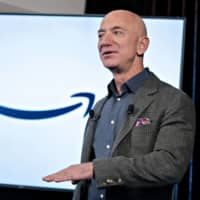 Amazon.com Inc. boss Jeff Bezos speaks at the National Press Club in Washington last September. Amazon is reportedly in talks to buy driverless vehicle startup Zoox Inc. | BLOOMBERG