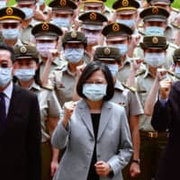 Taiwan President Tsai Ing-wen (center) poses for photographs with National Security Council Secretary-General Wellington Koo (left) and Defense Minister Yen Teh-fa while inspecting military police headquarters in Taipei on Tuesday. | AFP-JIJI