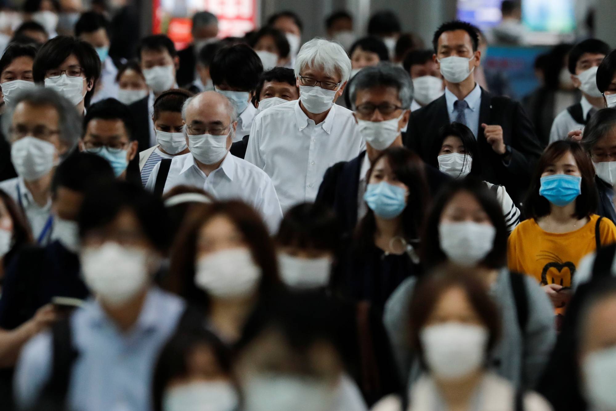 People make their way during rush hour at Shinagawa Station on Tuesday, a day after the government fully lifted the state of emergency. | REUTERS 