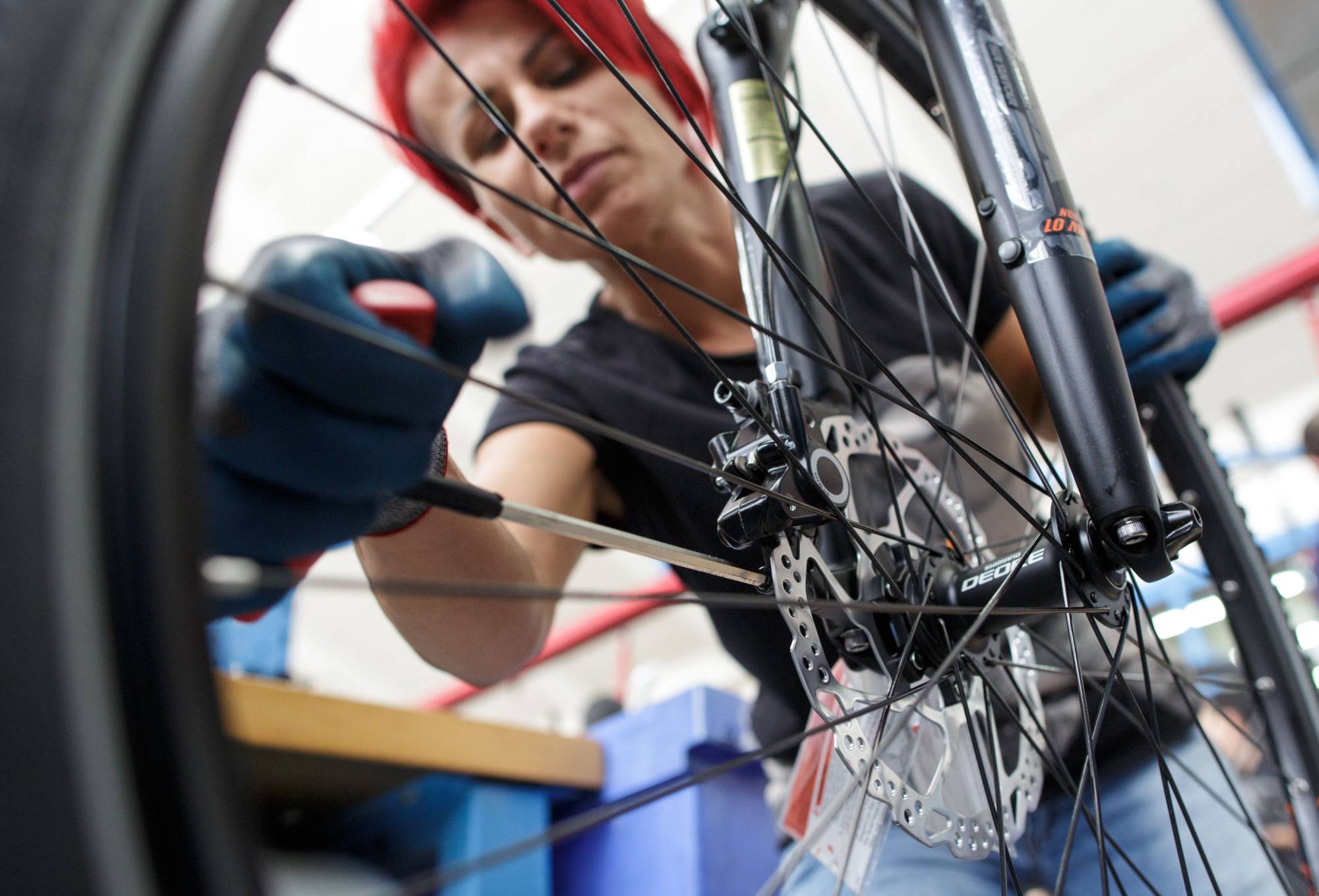 An employee installs a Shimano Inc. disc brake caliper to a bicycle in the assembly area inside the KTM Fahrrad GmbH bicycle manufacturing facility, in Mattighofen, Austria. | BLOOMBERG
