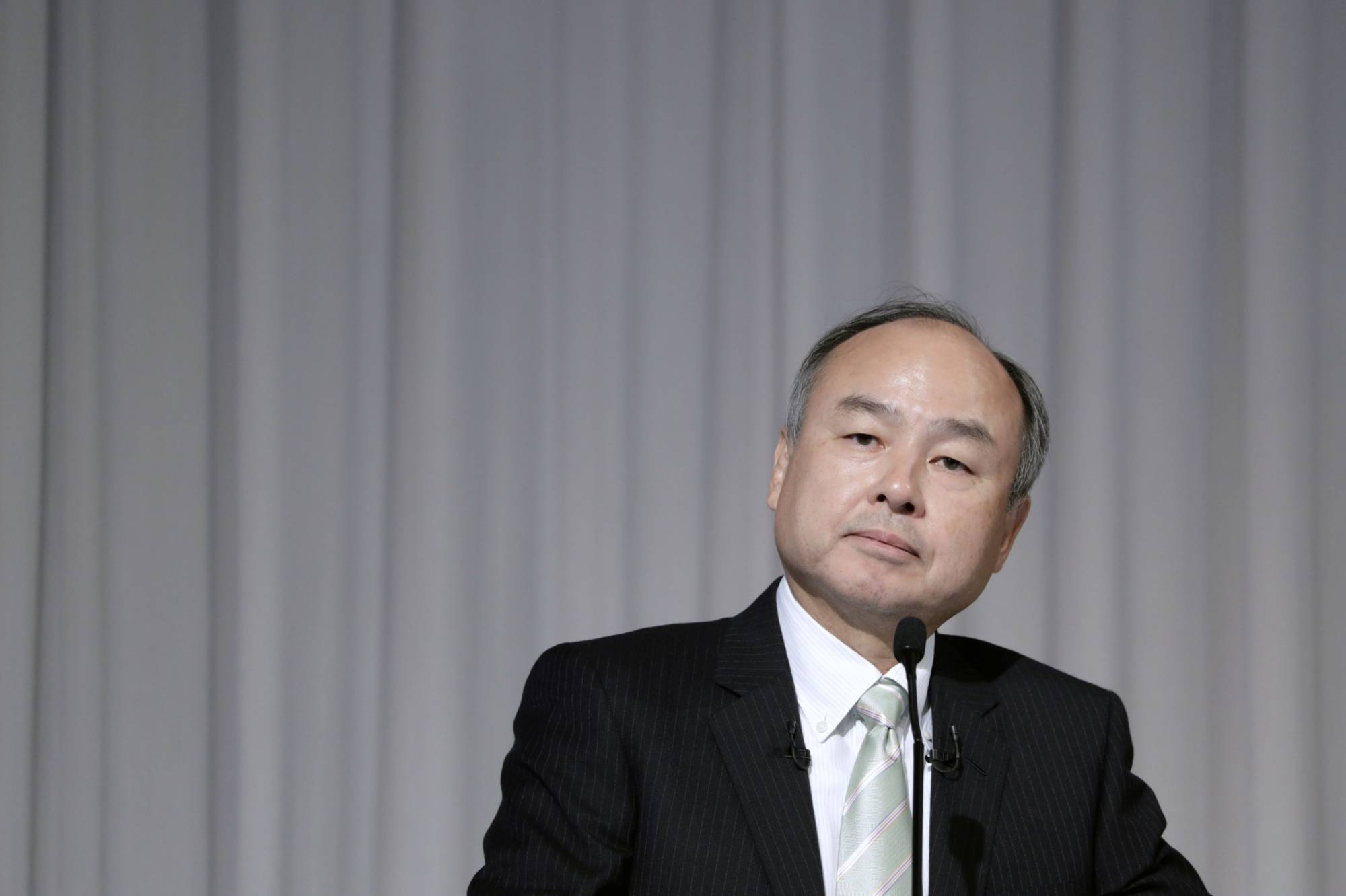 Masayoshi Son, chairman and chief executive officer of SoftBank Group Corp., listens during a news conference in Tokyo on Feb. 12. | BLOOMBERG