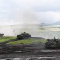 Ground Self-Defense Force vehicles take part in a live fire exercise in the East Fuji Maneuver Area in Gotemba, Shizuoka Prefecture, on Saturday. | AFP-JIJI /VIA BLOOMBERG